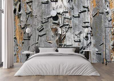 A view of a textured and nailed rough tree surface for backgrounds and textures Wall mural