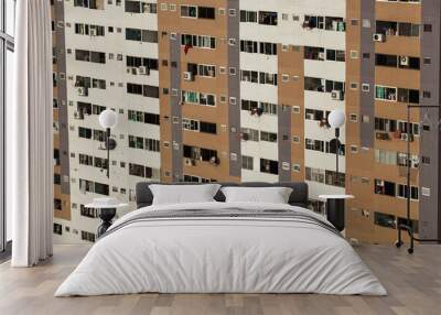 close up of old boring apartment house with many floors and satellite dishes and laundry at balconies  Wall mural