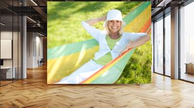 Happy senior woman in a park Wall mural