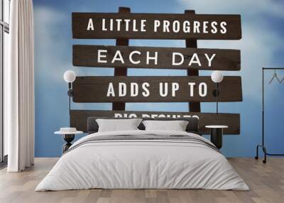 Motivational and inspirational quote - ‘A little progress each day adds up to big results’ on plank signage. With vintage styled background. Wall mural