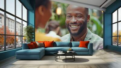 A smiling businessman doing a handshake with a businesswoman, at the office. Wall mural