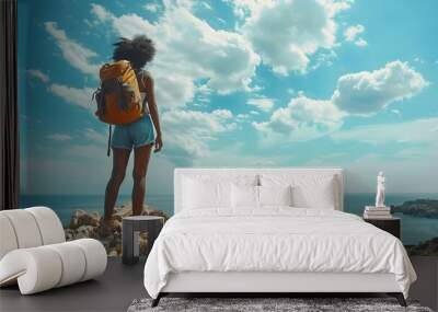 Black woman traveler standing on rocky cliff Wall mural