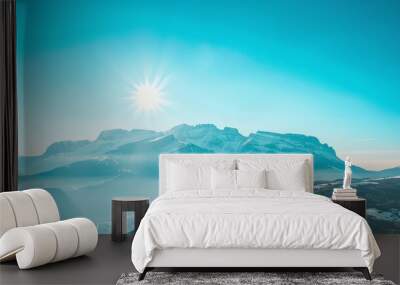 A bright, sunny day with a mountain range in the distance. Wall mural