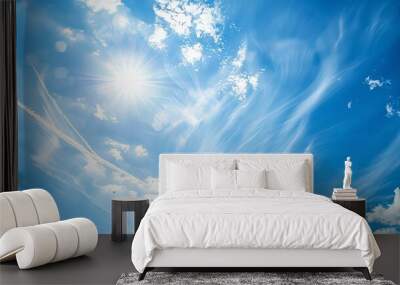 A bright blue sky with white clouds and contrails. Wall mural