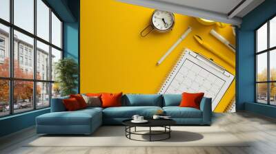 A flat lay of office supplies on a yellow background. Wall mural