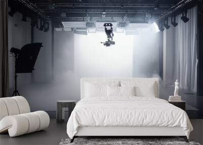 A professional photography or videography studio with a camera on a boom arm, lighting equipment, and a white backdrop, filled with atmospheric smoke. Wall mural