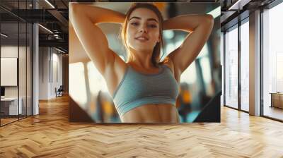 A woman in a gym, working out. Wall mural