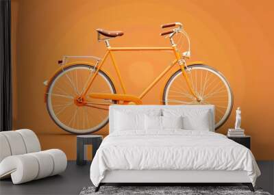 An orange bicycle on a bright orange background. Wall mural