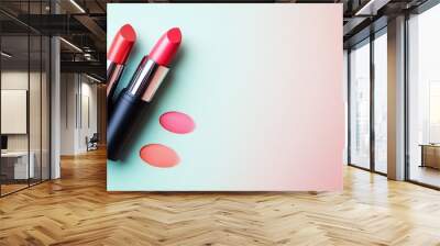 Two lipsticks on a blue and pink background. Wall mural