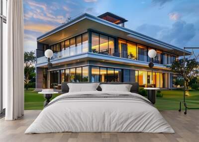 Modern luxury two-story house villa with pool and spacious balcony, glass windows, terrace overlooking the golf course at beautiful sunset. Modern architectural design home in the evening Wall mural