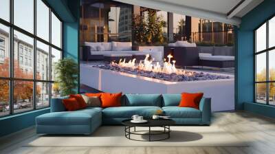 Outdoor fireplace patio with white exterior & modern courtyard setting. Large built-in gas flame fire pit. Outdoor seating lounge area. Cozy place. Wall mural