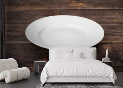 White empty plate on dark wooden table Wall mural