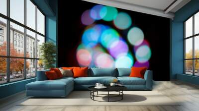 Colorful bokeh lights at night with a black background Wall mural