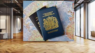 two british passports overlapping on a map of the world implying travel around the world Wall mural