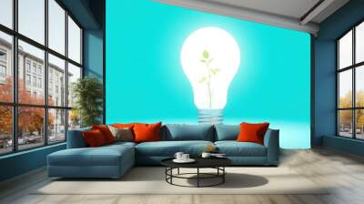 Green Plant Growing Inside Light Bulb on Blue Background. Innovation Sustainability and Green Energy Growth Concept Wall mural