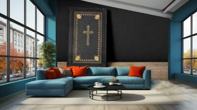 Church faith Christian background - Old holy bible with golden cross on old rustic vintage wooden table and black wall Wall mural