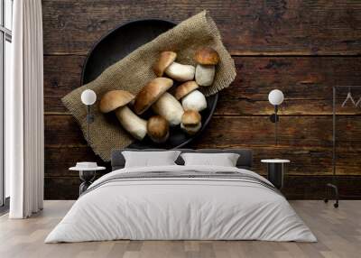 Fresh forest mushrooms /Boletus edulis (king bolete) / penny bun / cep / porcini in an old bowl / plate on the wooden dark brown table, top view background Wall mural