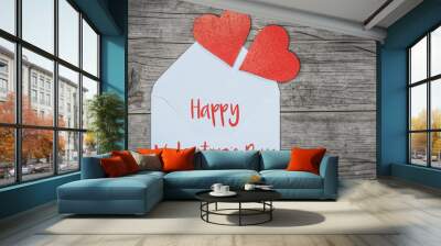 Happy Valentine's Day greeting card concept. White envelope with two red hearts on rustic brown wooden wood table texture background top view. Flat lay.
 Wall mural