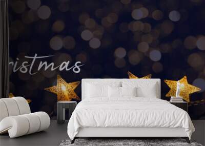 Merry Chrsitmas celebration decoration holiday background banner panorama - Golden star light chain hanging on dark night sky with bokeh Wall mural