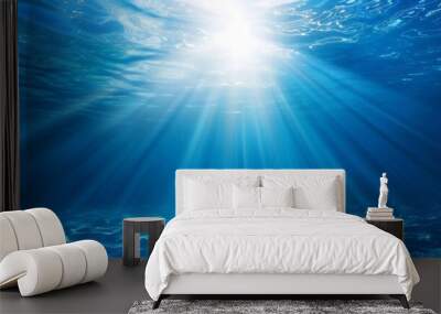 Ocean background - Sun shining light sunlight sunshine in blue clearly deep water, sunbeams illuminate the blue underwater sea scene Wall mural