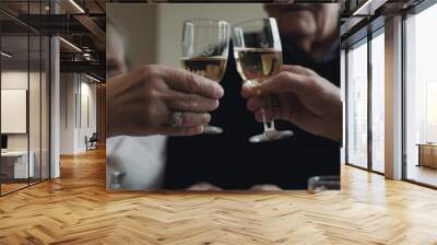 Hands holding two chalices of champagne and toasting. New year celebration concept, fancy party photography Wall mural