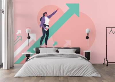 Leadership, leading to success or business vision concept. Businesswoman is pointing direction forward and standing on flying arrows in pink background. Wall mural