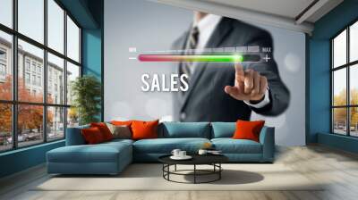 Sales growth, increase sales or business growth concept. Businessman is pulling up progress bar with the word SALES on bright tone background. Wall mural