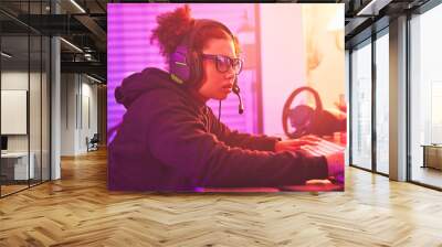 Computer games, young girl and headset in home for esports, online rpg and virtual competition. Female gamer, internet streamer and gaming on headphones in neon lighting, live streaming tech or gen z Wall mural