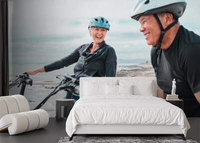 Laughing couple, helmet or electrical bike by sea in transportation, clean energy or sustainability travel bonding. Technology, electric or eco friendly bicycle for funny woman or mature cycling man Wall mural