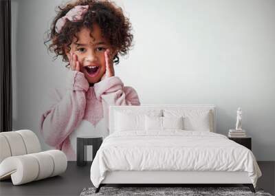 Oh my goodness. Shot of a adorable little girl looking surprised against a grey background. Wall mural