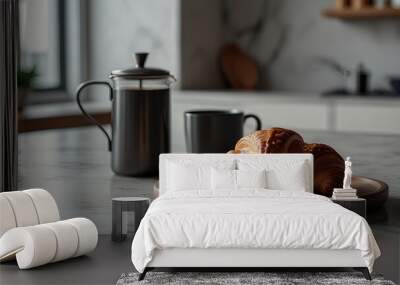 Wooden plate with fresh tasty croissant and cup of coffee or tea on white marble countertop. Blurred modern kitchen interior background. Cozy morning breakfast concept Wall mural