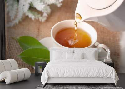 Close up pouring hot black tea in a white tea cup ,  Tea ceremony time concept Wall mural