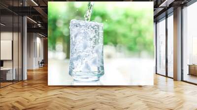 the glass of cool water with some water flow down motion Wall mural