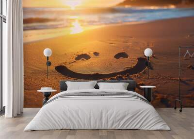 Smiley face drawn in sand at sunset on a beach Wall mural