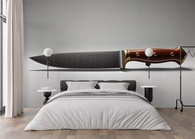 Large sharp hunting knife is laying on a white surface Wall mural