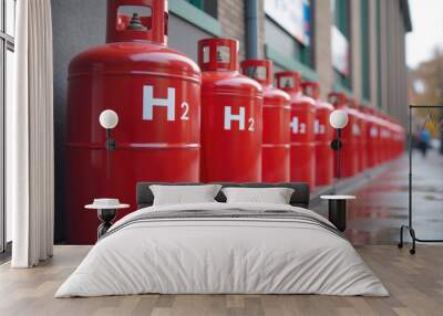 Many red gas cylinders full of hydrogen h2 standing on wet sidewalk Wall mural