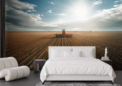 Tractor works in field against the backdrop of sunset. The concept of development of agriculture and farming Wall mural