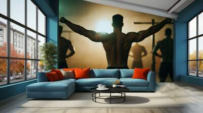 Work in the gym. Men preparing to exercise on the horizontal bar. Silhouettes. View from the back. Little light Wall mural