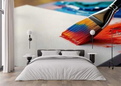 A vibrant paintbrush applies colorful strokes to a blank canvas, showcasing creativity and artistic expression. Wall mural