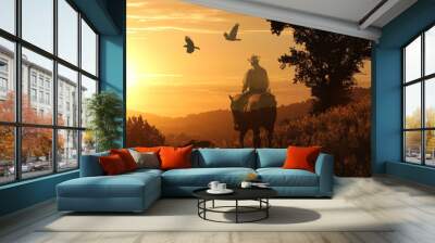 A cowboy riding into the golden sunset on a orange meadow with birds flying above. Wall mural