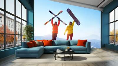 Active skier and snowboarder against mountains Wall mural