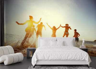 Big group friends sunset sea beach run Wall mural