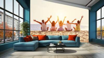 Big happy family or friends having fun against sunset beach Wall mural