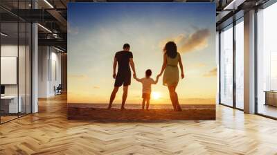 Family of three person is standing on sunset and sea backdrop Wall mural