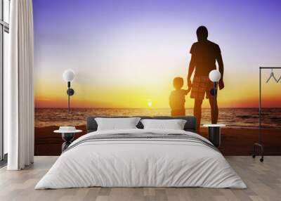 Father and son at sunset beach Wall mural