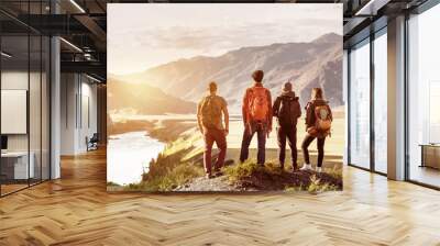 Four friends sunset mountains travel concept Wall mural