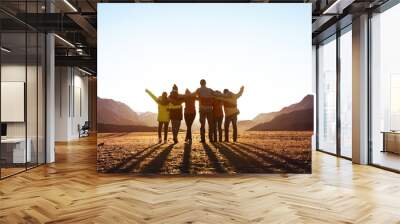 Group of friends against sunset mountains Wall mural