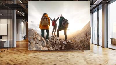 Group of happy young tourists relax on view point in mountains Wall mural