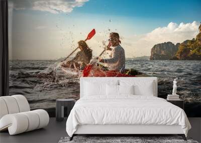 Happy couple having fun and walks on kayaks Wall mural