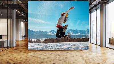 Happy girl jumps with snow winter concept Wall mural